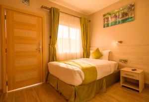 Postel nebo postele na pokoji v ubytování Abai Lodges & Spa