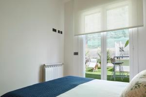 a bedroom with a bed and a view of a patio at Arzak by FeelFree Rentals in San Sebastián