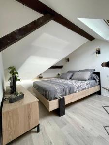 a bedroom with a large bed in a attic at Petit studio vue lac / La Talloirdaze in Talloires