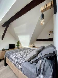 a bedroom with a large bed in a attic at Petit studio vue lac / La Talloirdaze in Talloires