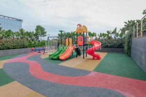 a playground with a slide and a slidesktop at RedLiving Apartemen Sayana - Family Group Property Tower Cha in Hutanhawit