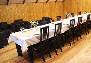 a long table with black chairs and white table cloth at Splendor Resort and Restaurant in Tsaghkadzor