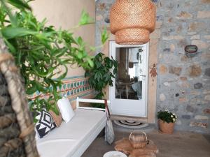a living room with a white couch and a mirror at Aretousa Deluxe Downtown Apartment in Skala