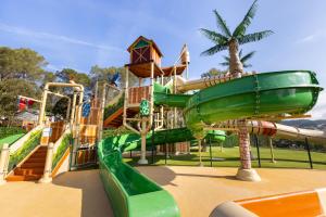 a water park with a slide and a water slide at Frantheor Fréjus 5 étoiles in Fréjus