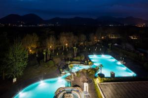 an aerial view of a pool at night at Hotel Sporting Resort in Galzignano