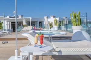 two cocktails on tables on the roof of a building at Marins Playa in Cala Millor