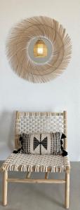 a circular light fixture above a bench in a room at Sun House Paros in Kampos Paros