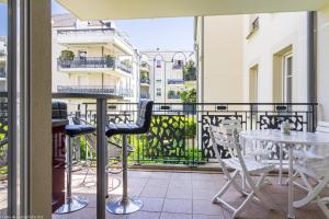Un balcón con una mesa y sillas en un balcón. en Résidence Egalité - Montmartre, en Dijon