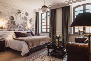 a bedroom with a bed and a couch at Château Laffitte Carcasset in Saint-Estèphe