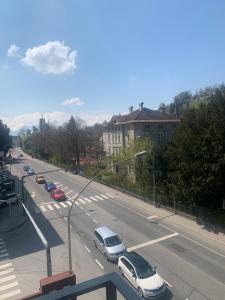 a view of a street with cars parked on the road at Smart Stay Apartment in Feldkirch