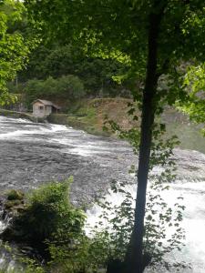 a house in the middle of a river at Apartment Nura in Bihać