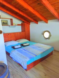 a large bed in a room with a wooden ceiling at ART STUDIO capitain in Sinemorets