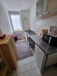 a kitchen with a sink and a counter top at Monteurwohnung App 5 in Pirmasens
