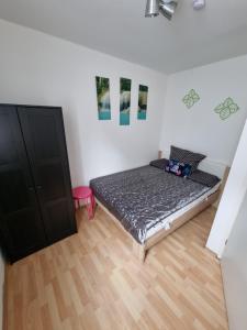 a bedroom with a bed and a wooden floor at Monteurwohnung App 5 in Pirmasens