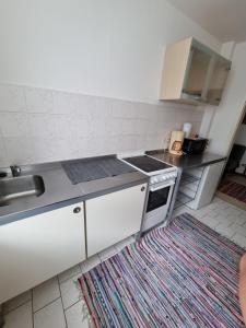 a kitchen with a sink and a stove top oven at Monteurwohnung App 5 in Pirmasens