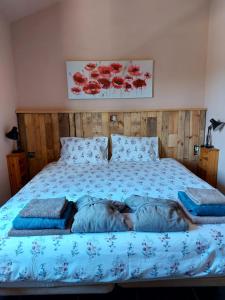 a bedroom with a bed with red flowers on it at Quinta Cunte - Casa Girassol in São Luis