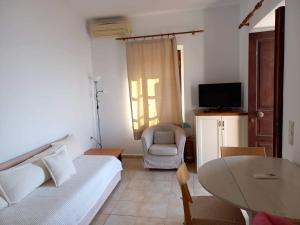 a bedroom with a bed and a table and a chair at Villa Amalia in Halki
