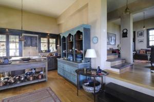 a large kitchen with blue cabinets and a table at Bird's eye-view in Zagora