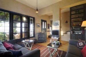 a living room with a couch and a tv at Bird's eye-view in Zagora
