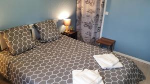 a bedroom with a bed with two towels on it at Maison, jardin, barbecue et vélo classé 3 étoiles in Dives-sur-Mer