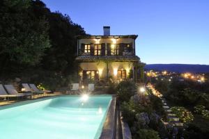 a house with a swimming pool in front of a building at Bird's eye-view in Zagora