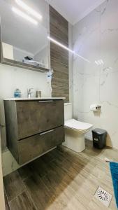 een badkamer met een wastafel en een toilet bij Glyfada beach two floors apartment 2-3 people in Glyfada