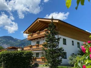 un grande edificio bianco con tetto in legno di Ferienwohnung Hoffmann-Schiffer a Bischofswiesen