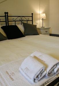 a bed with two towels sitting on top of it at Tenuta Orsanese in Ginosa Marina