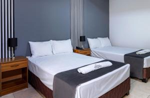 Ένα ή περισσότερα κρεβάτια σε δωμάτιο στο Hotel Taurus