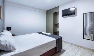 Ένα ή περισσότερα κρεβάτια σε δωμάτιο στο Hotel Taurus