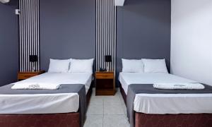 Ένα ή περισσότερα κρεβάτια σε δωμάτιο στο Hotel Taurus