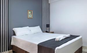 Ένα ή περισσότερα κρεβάτια σε δωμάτιο στο Hotel Taurus