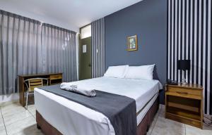 Ένα ή περισσότερα κρεβάτια σε δωμάτιο στο Hotel Taurus