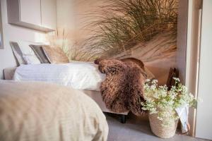 Ένα ή περισσότερα κρεβάτια σε δωμάτιο στο Ecohome Veer - Zeezand Recreatie