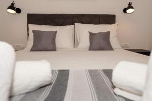 a bedroom with a large bed with pillows at Penthouse Paola- Modern and Luxury apartment in Zadar in Zadar