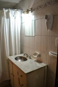 a bathroom with a sink and a mirror at Hostel Ruta76 in Sierra de la Ventana
