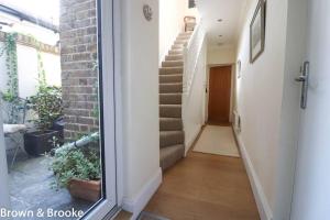 a hallway with a stairway with a stair case at Stylish & spacious 3 bed Victorian house sleeps up to 7 - near O2, Museums, Excel, Mazehill station 12 mins direct into London Bridge in London