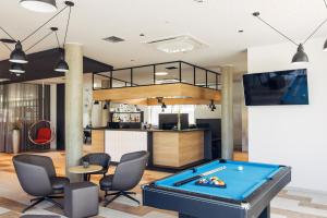 a pool table in the middle of a room at harry's home hotel & apartments in Telfs