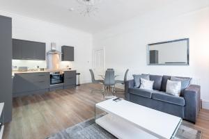 uma sala de estar com um sofá e uma mesa em River View Apartment em Dundee