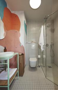a bathroom with a shower and a toilet and a sink at SmartApart in Budapest