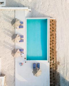 an overhead view of a room with a blue door and chairs at Sun House Paros in Kampos Paros