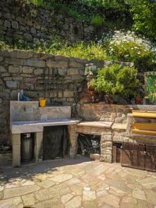 a stone wall with a bench and some plants at La Valle degli Orti in La Spezia