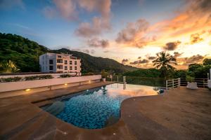 a large swimming pool in front of a building at Kata Ocean View condominium by Lofty in Kata Beach