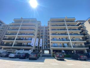 a parking lot in front of two tall buildings at Luxury Studio Solid Butoaie in Mamaia