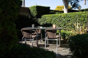 a table and chairs sitting on a patio at Constantia Manor Guest House in Pretoria