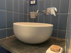 a white bowl sink on a counter in a bathroom at Cà Della Valletta in Riomaggiore +12 photos