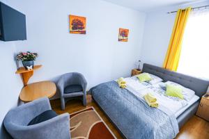 a bedroom with a bed and a table and chairs at Villa Nadmorska Łeba Centrum in Łeba +57 photos