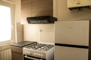 una cucina con piano cottura e frigorifero di Bed and Breakfast La Villa a Fiastra