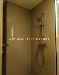 a shower in a bathroom with a not available caza at D'Vanaest in Semarang