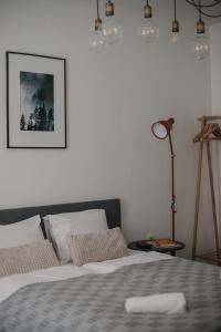 a bedroom with a bed and a picture on the wall at Gallery Apartment 2 in Martin